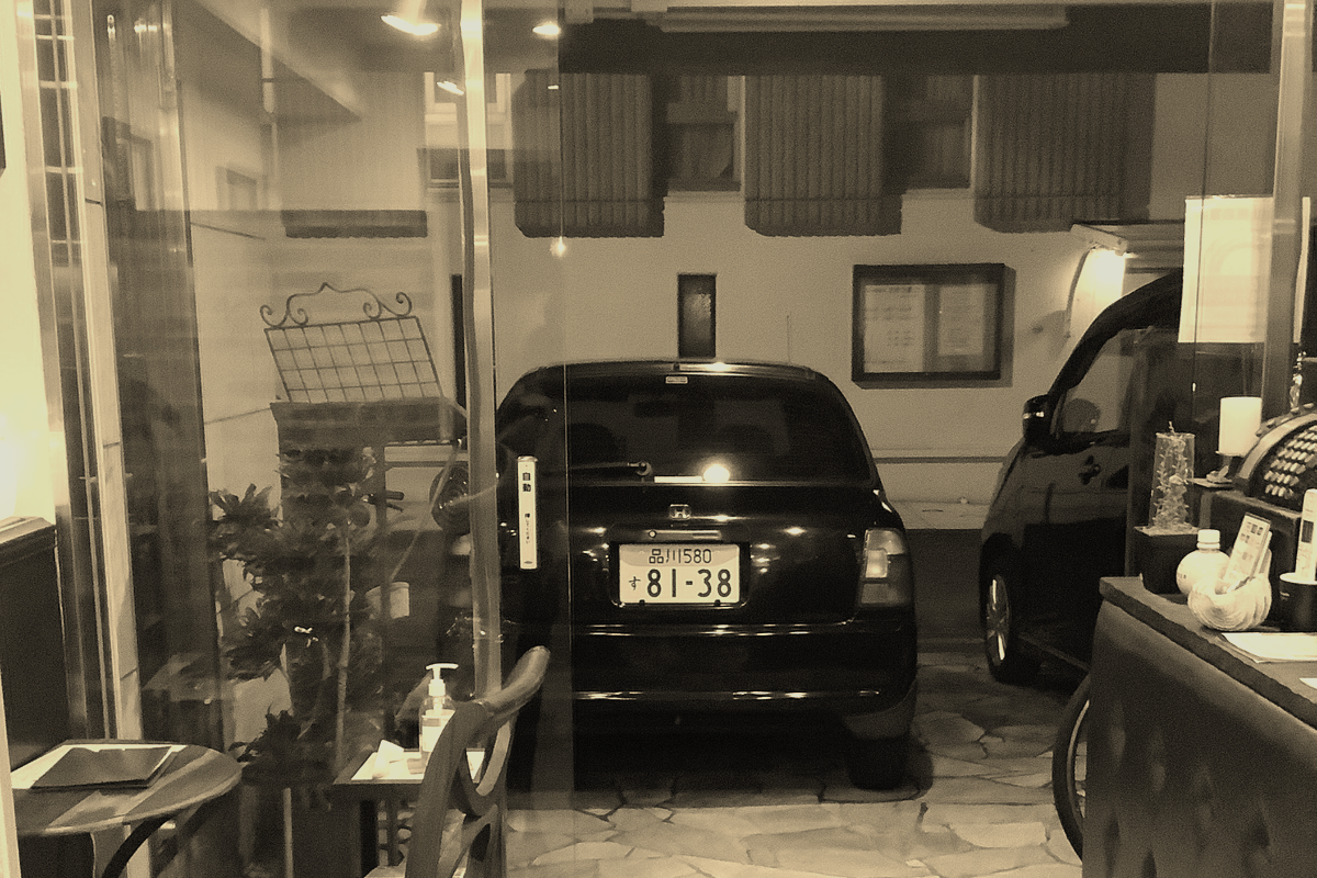 A quiet view into a Japanese garage setting, suggesting place, atmosphere, and trust.